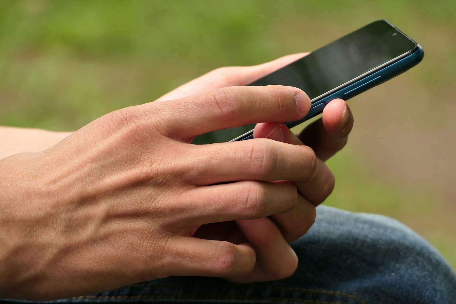 Cell phone, smartphone in the hands of a man.